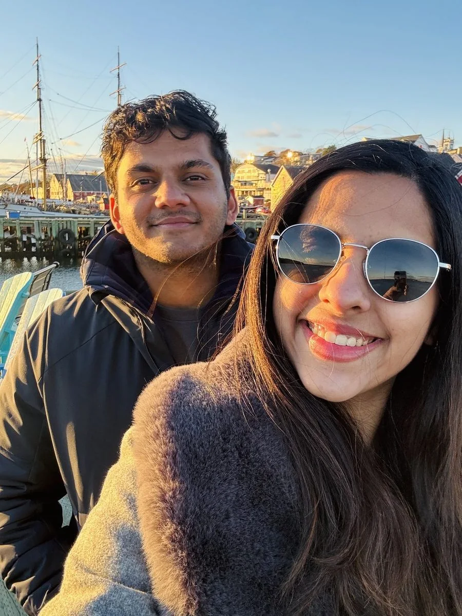 Harini and Chinmay by the harbour at golden hour